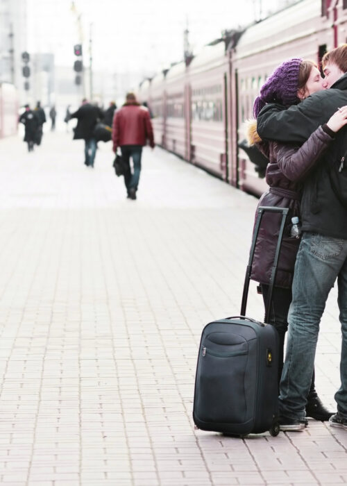 Happy,Young,Couple,On,Railway,Station,Platform