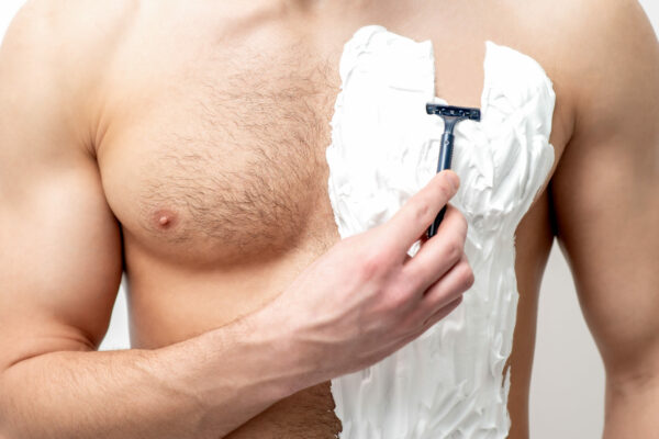 Young,Caucasian,Man,With,Beard,Holds,Razor,Shaves,His,Chest
