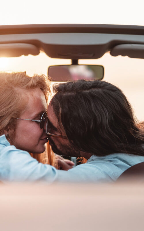 Happy,Couple,Kissing,In,Convertible,Car,-,Romantic,People,Having